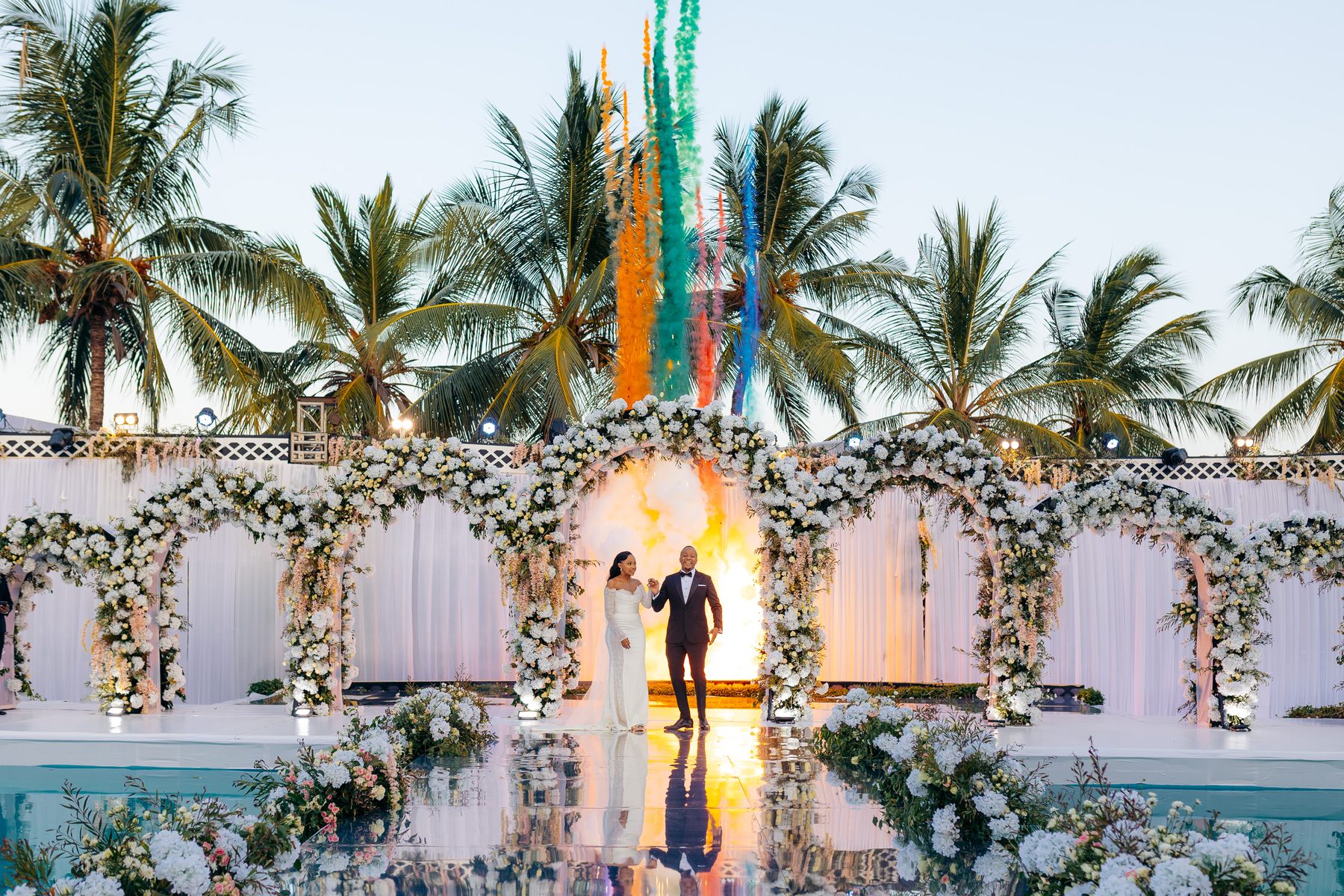 Ali & Dr. Lucy wedding in Tanga, Tanzania, by Kevins Events — colourful smoke jets over the coastal ceremony