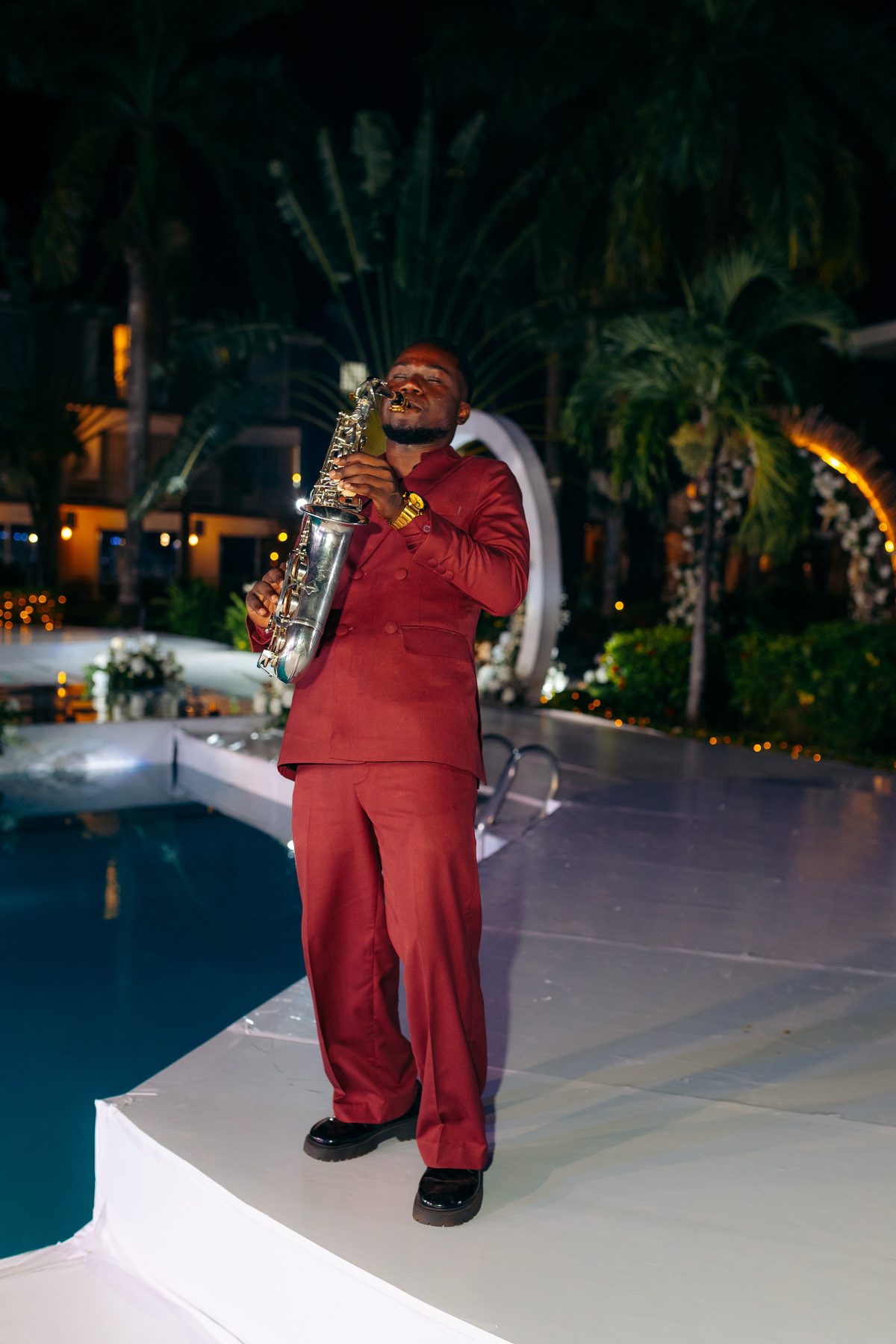 Ali & Dr. Lucy wedding in Tanga, Tanzania, by Kevins Events — a saxophonist performing poolside
