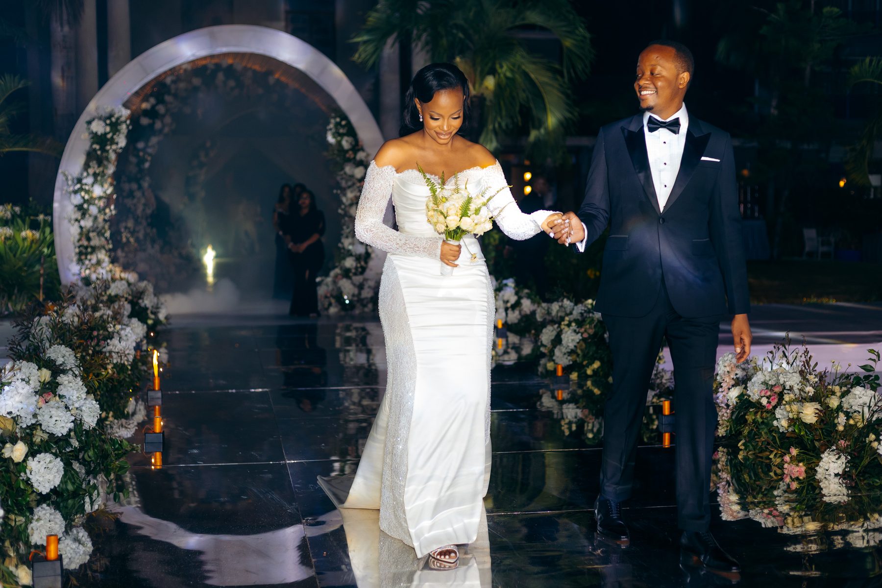 Ali & Dr. Lucy wedding in Tanga, Tanzania, by Kevins Events — the couple's entrance on the mirrored walkway