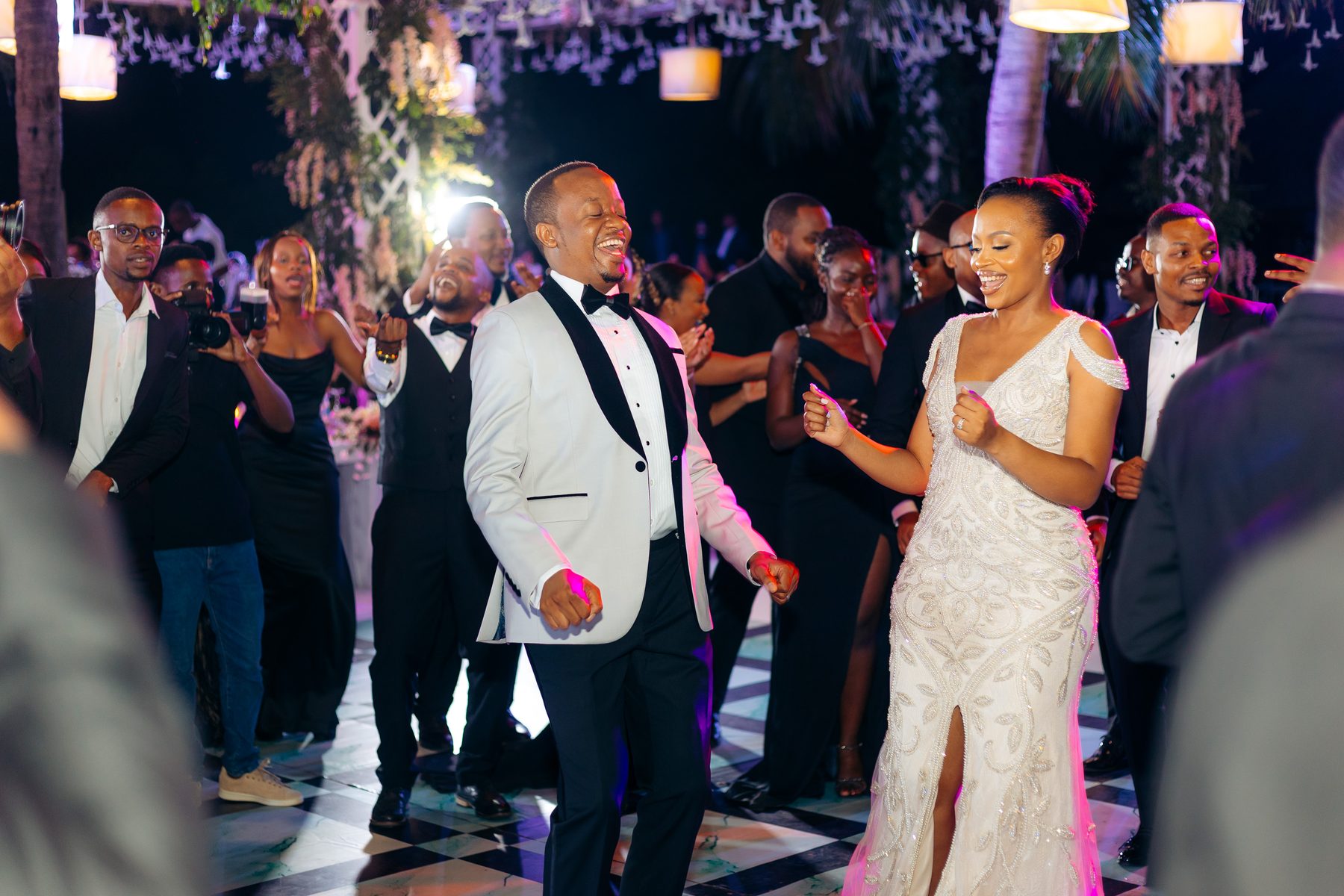Ali & Dr. Lucy wedding in Tanga, Tanzania, by Kevins Events — the couple dancing with guests at the reception