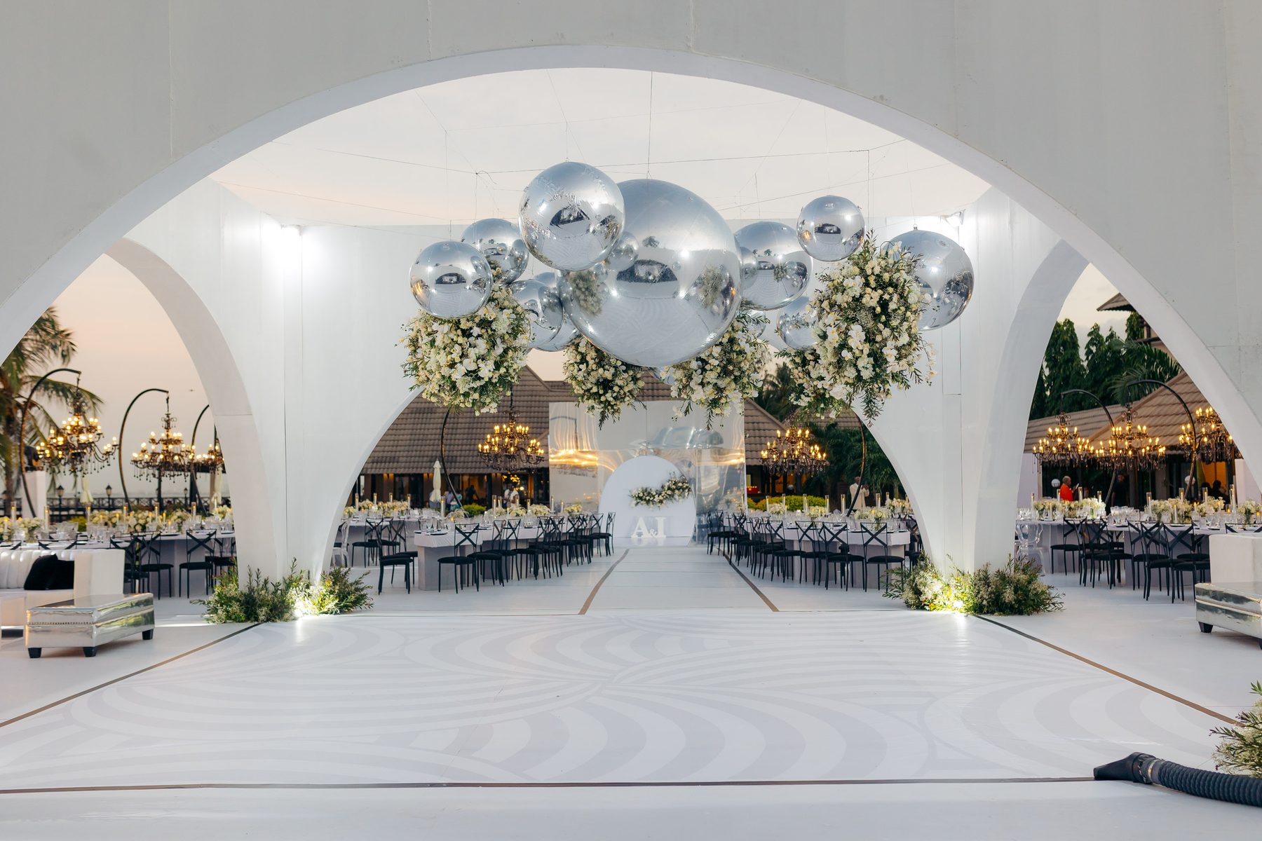 Anthony & Irene wedding at White Sands Resort, Dar es Salaam, by Kevins Events — silver orbs and florals beneath the arch