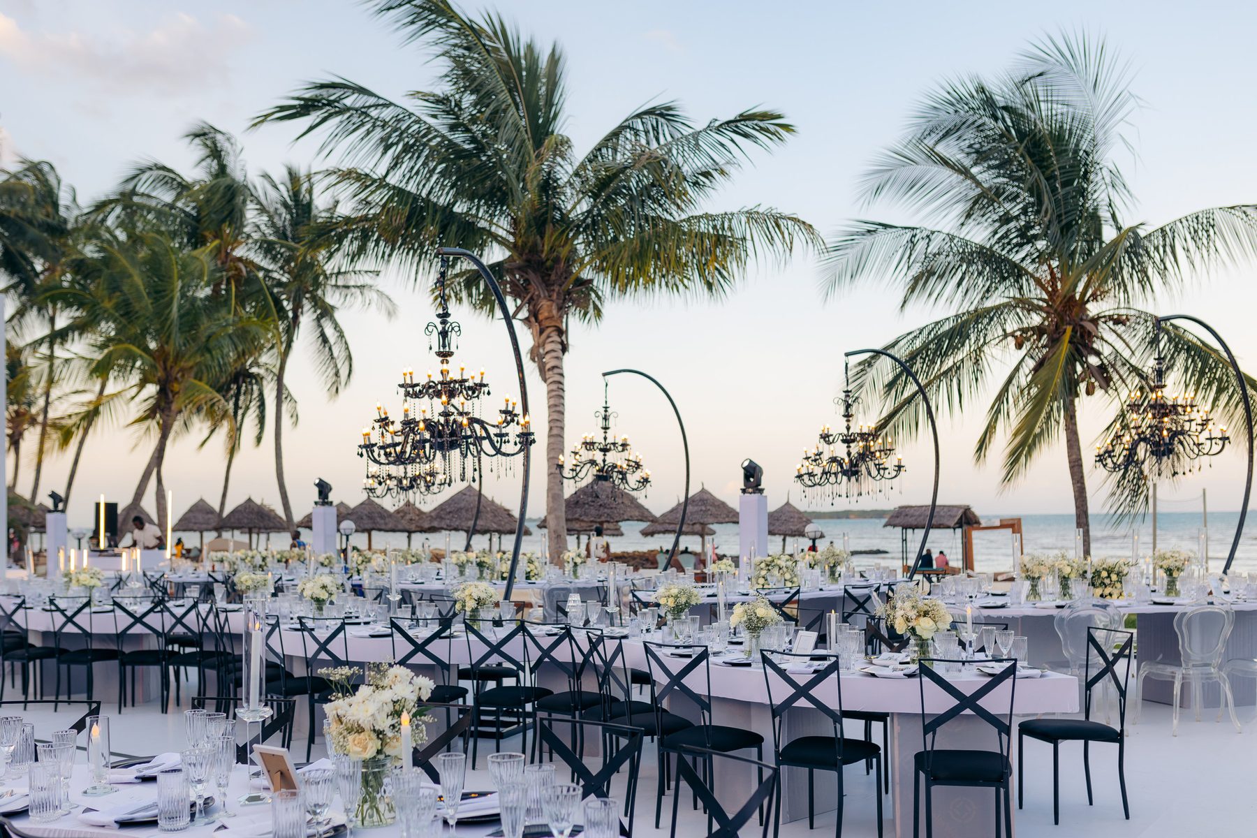 Anthony & Irene wedding at White Sands Resort, Dar es Salaam, by Kevins Events — beachfront dining beneath black chandeliers