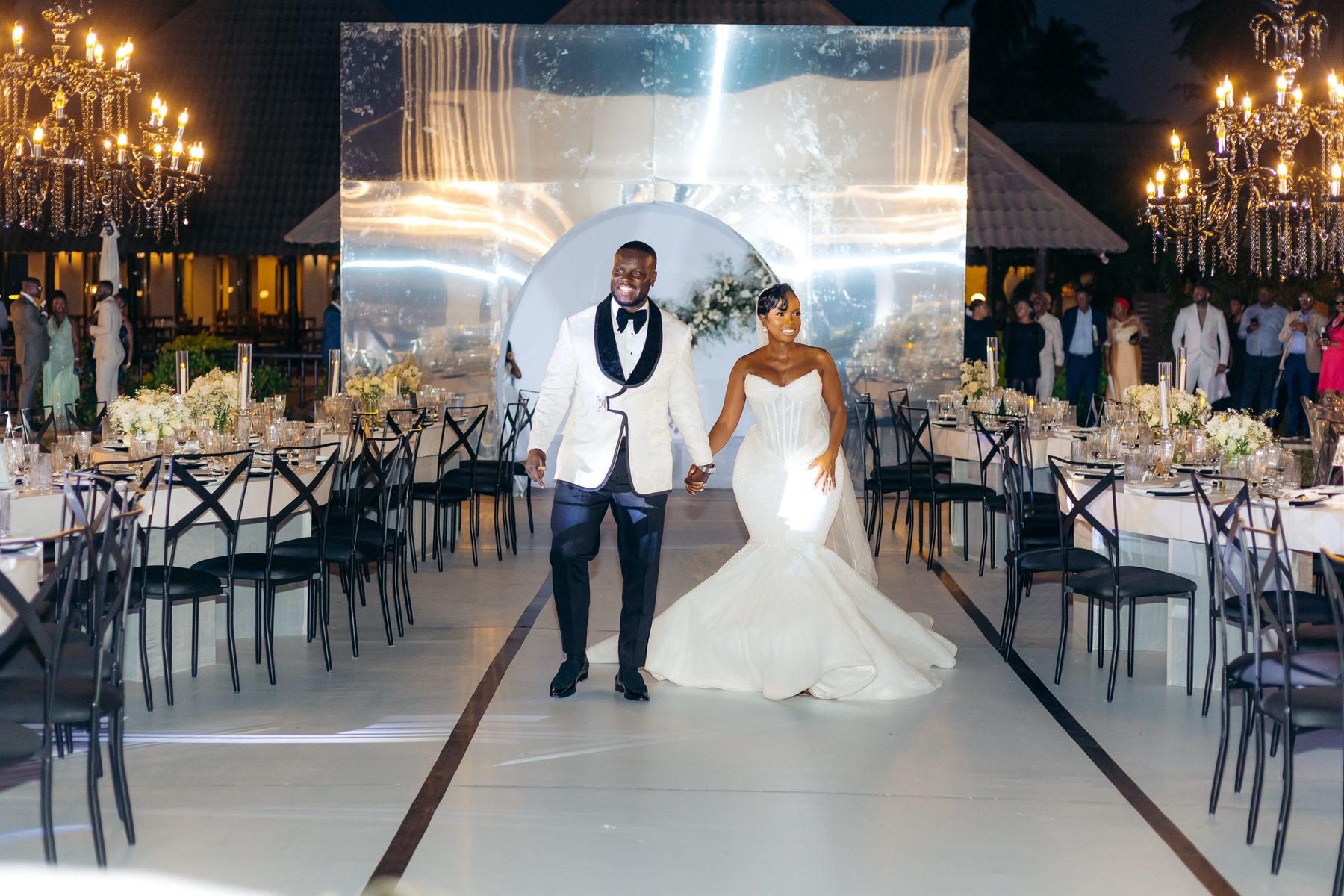 Anthony & Irene wedding at White Sands Resort, Dar es Salaam, by Kevins Events — the couple's entrance through the mirrored arch