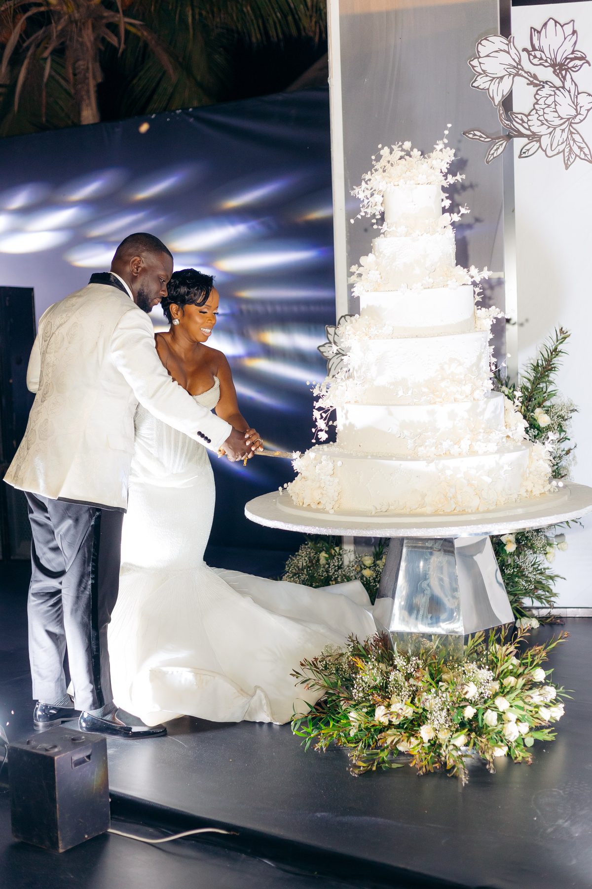 Anthony & Irene wedding at White Sands Resort, Dar es Salaam, by Kevins Events — cutting the tiered wedding cake