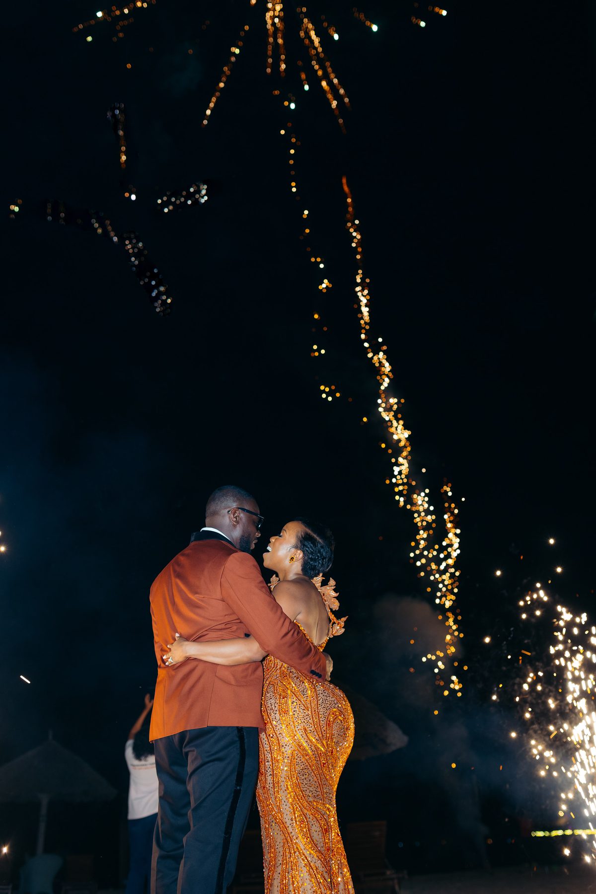 Anthony & Irene wedding at White Sands Resort, Dar es Salaam, by Kevins Events — an embrace beneath the fireworks