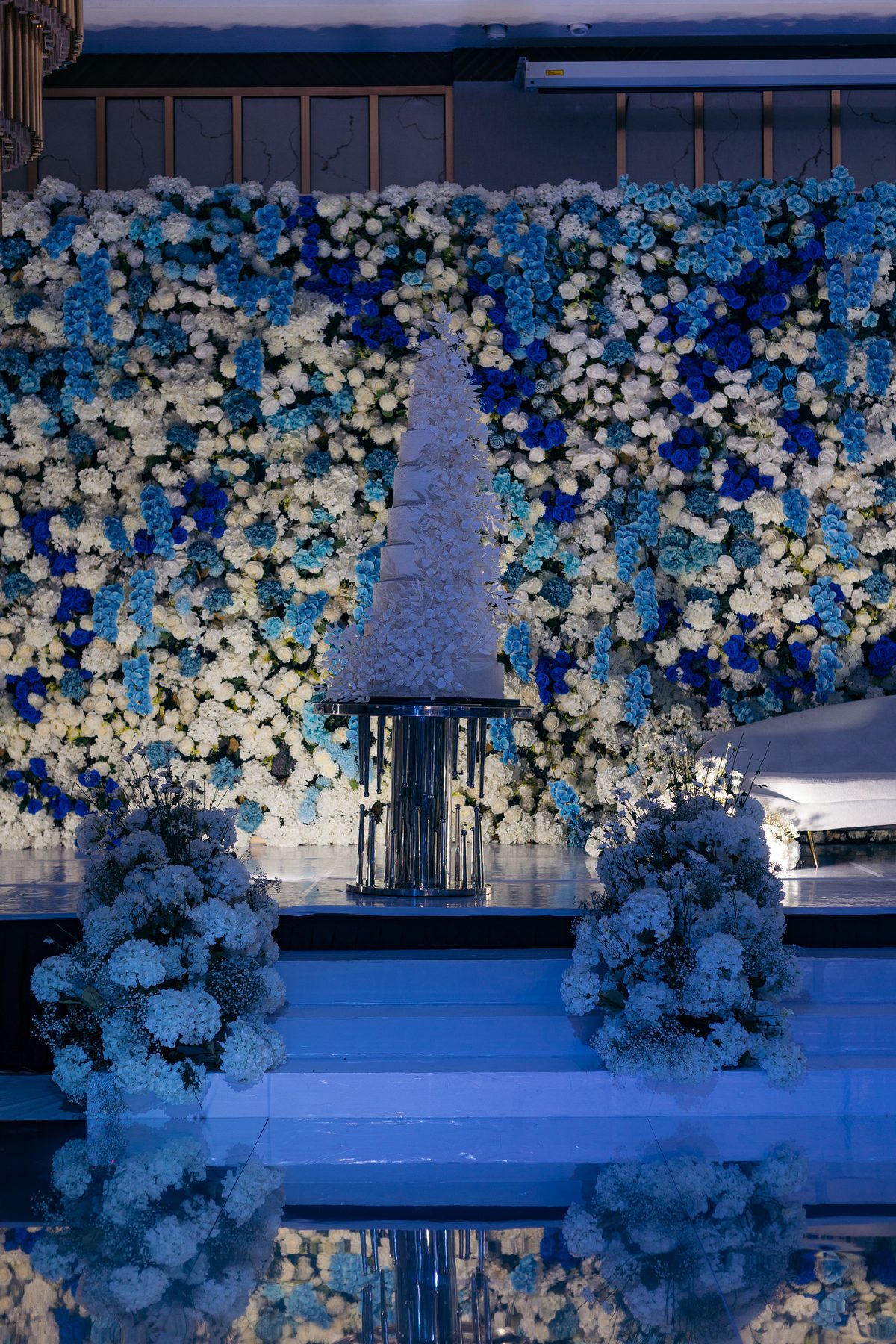 Hamis & Sabrina wedding at Johari Rotana — the wedding cake against the floral wall — by Kevins Events