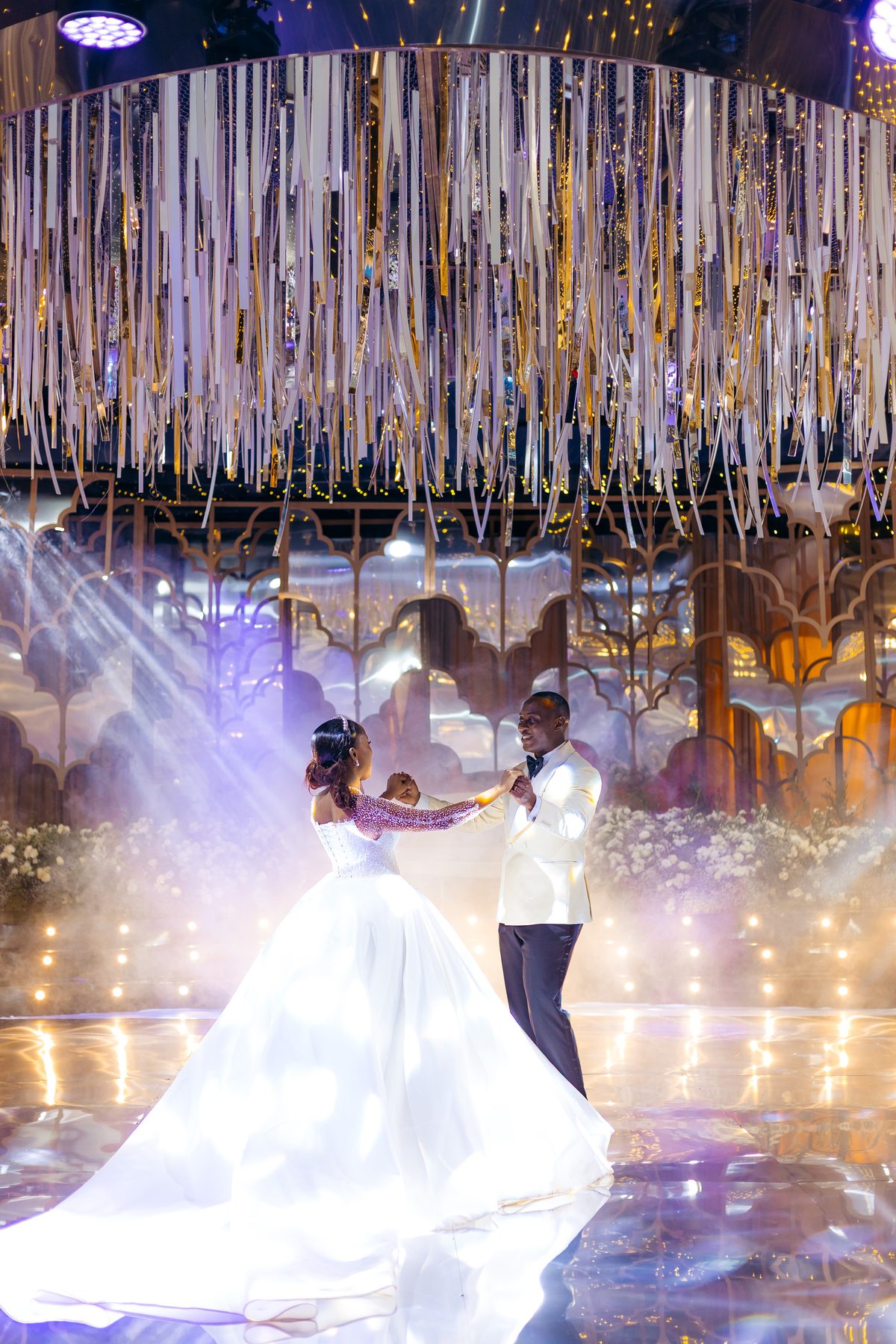 Jordan & Doria wedding at Serena Hotel, Dar es Salaam, by Kevins Events — first dance beneath the gold ribbon canopy