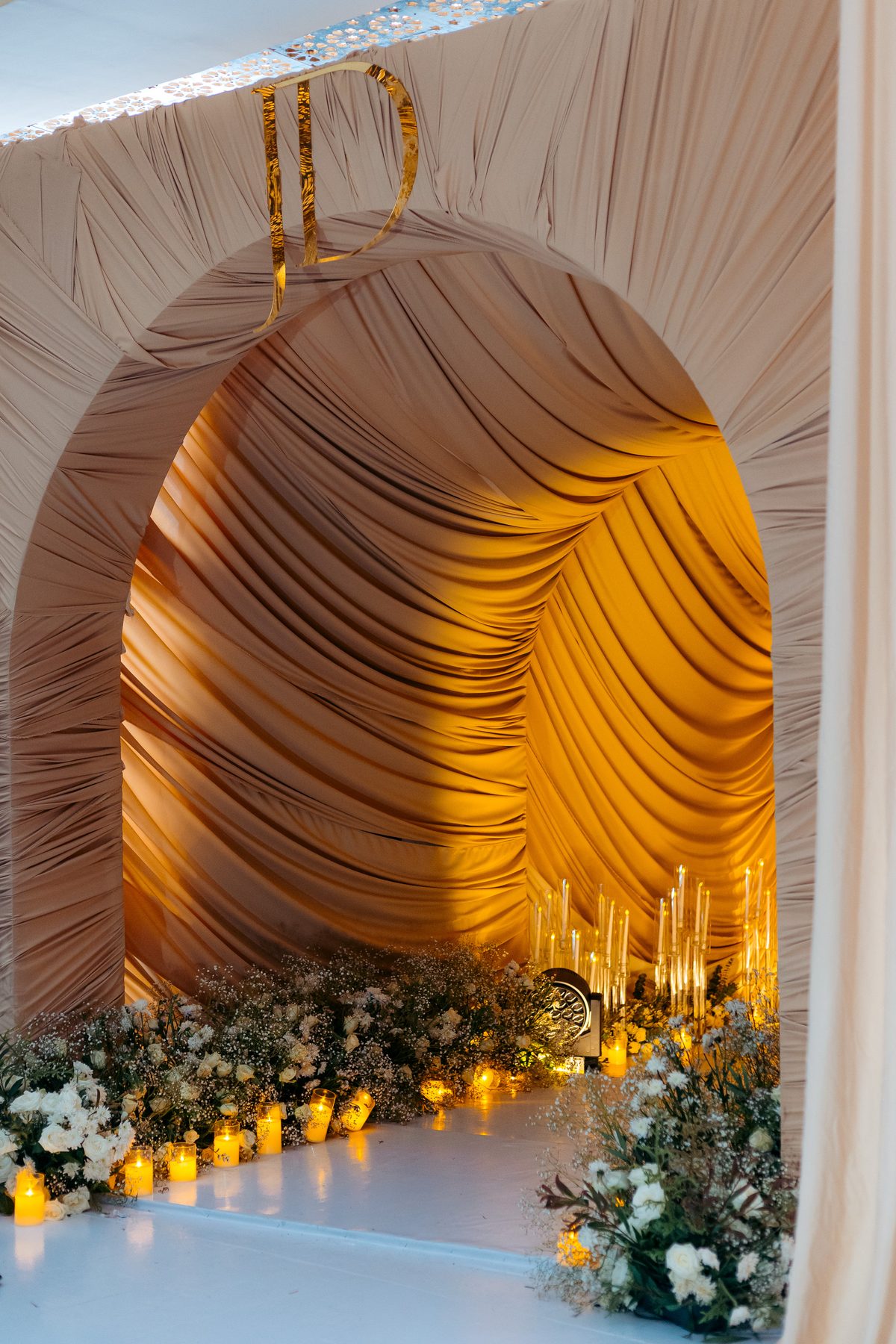 Jordan & Doria wedding at Serena Hotel, Dar es Salaam, by Kevins Events — candlelit draped arch backdrop