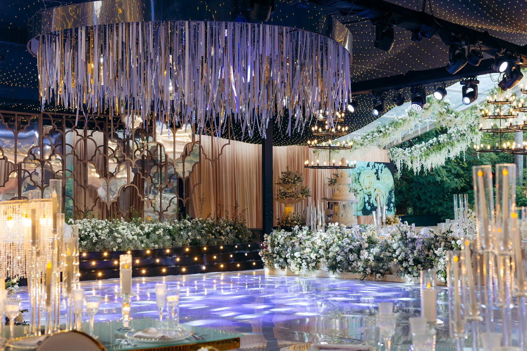 Jordan & Doria wedding at Serena Hotel, Dar es Salaam, by Kevins Events — reception view toward the cake and fringe chandelier