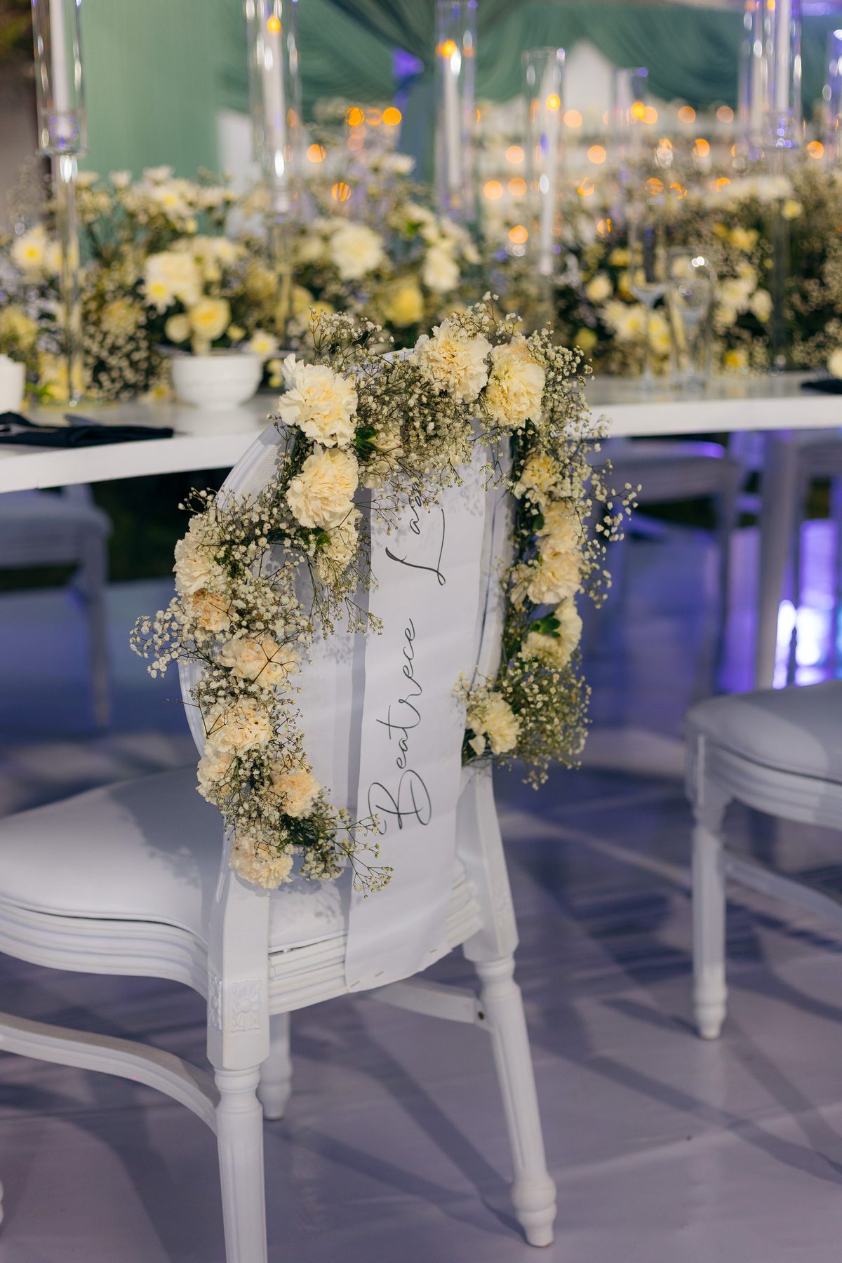 With Love, Bea — Beatrice's celebration at Kili Seasons, Arusha, by Kevins Events — floral-wreathed named chair detail