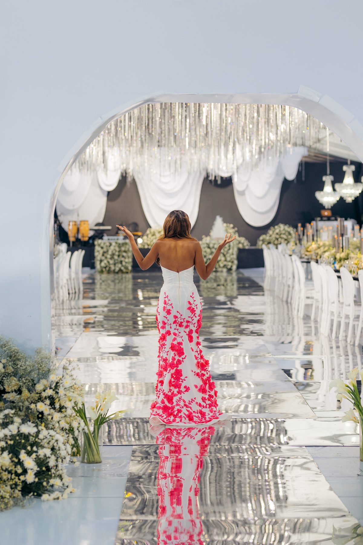 With Love, Bea — Beatrice with arms raised on the mirrored aisle at Kili Seasons, Arusha, by Kevins Events