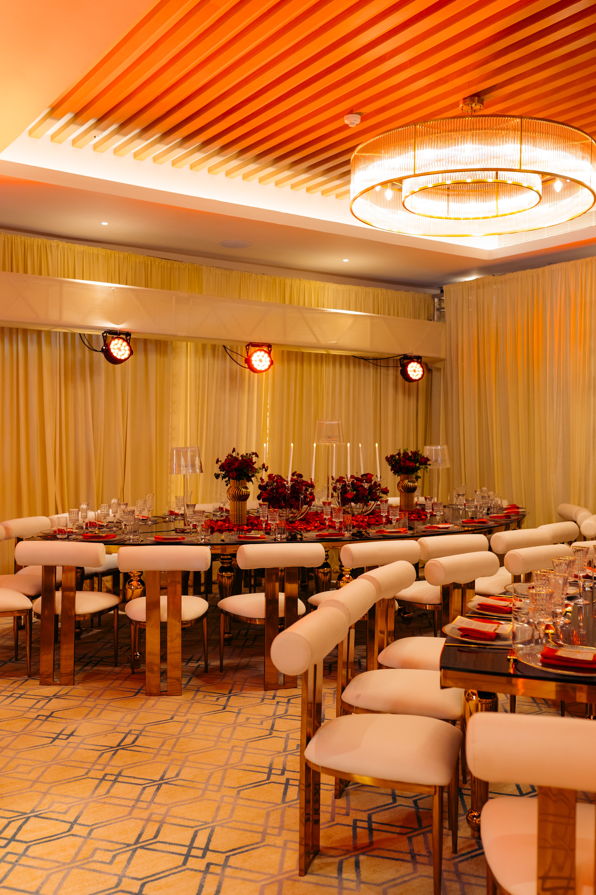 Intimate dining room setup with gold chairs and crystal chandelier — Kevins Events