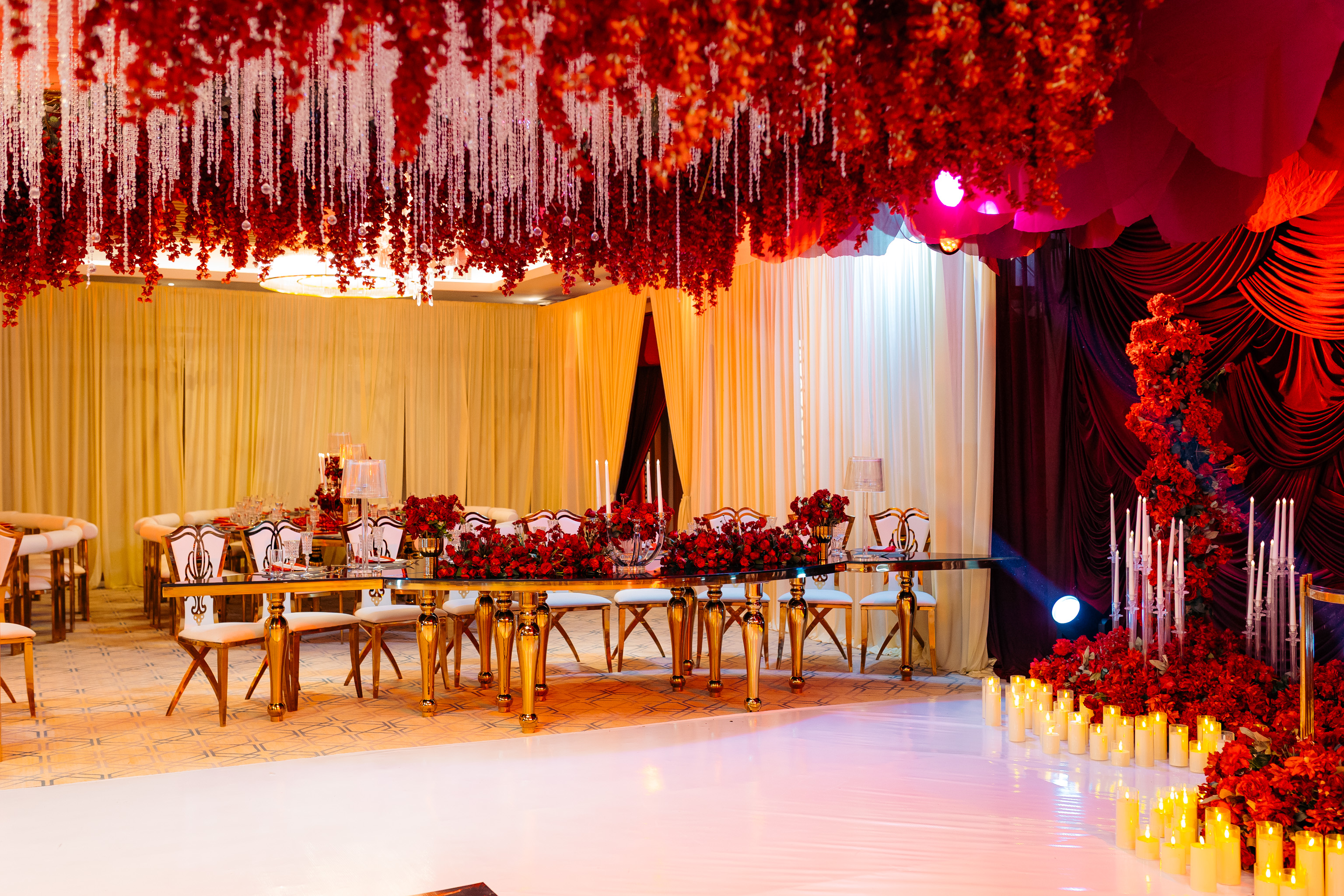 Full room view of Anne's birthday with red floral ceiling installation — Kevins Events Dar es Salaam