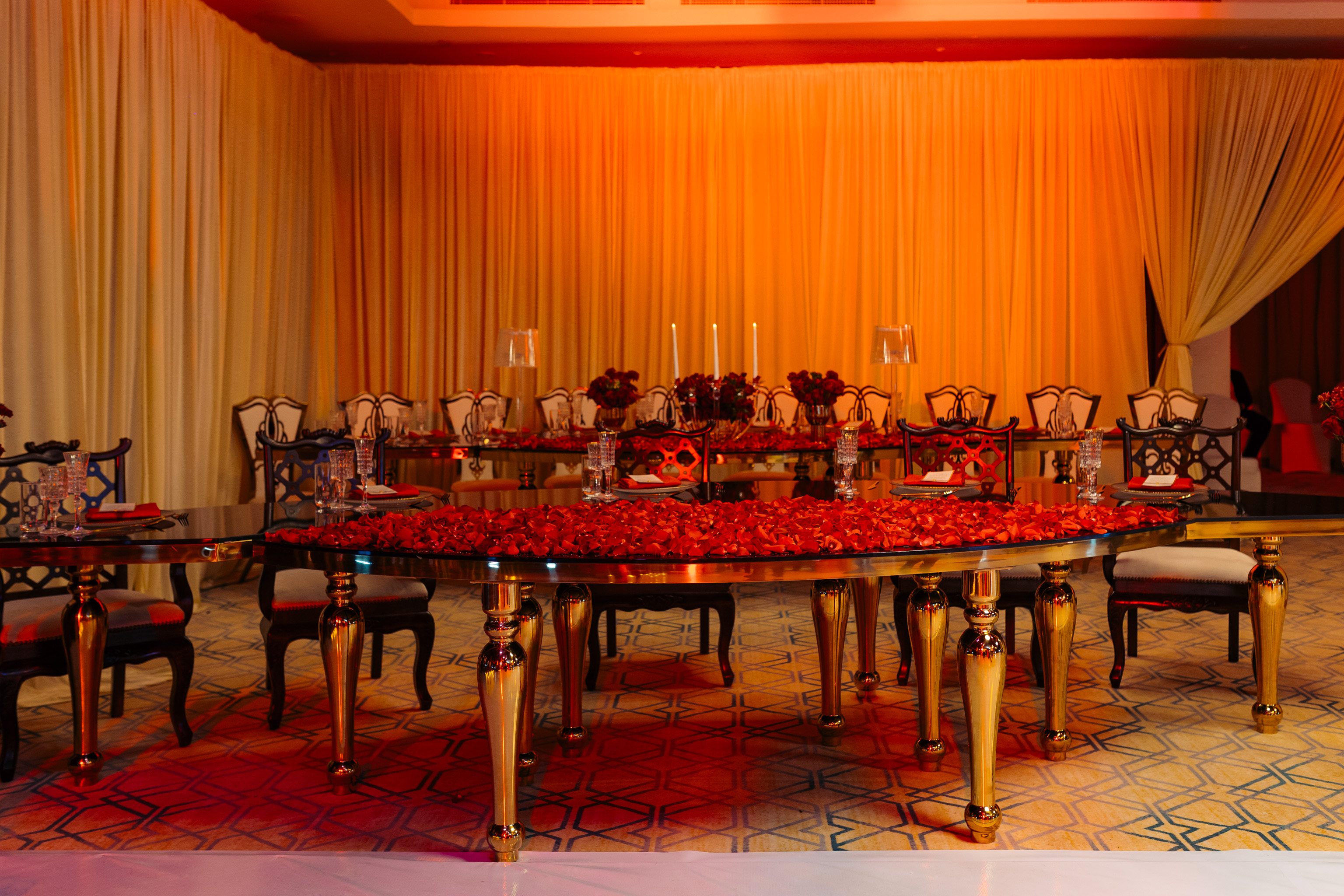 Gold dining table with red rose petals for Anne's birthday — Kevins Events