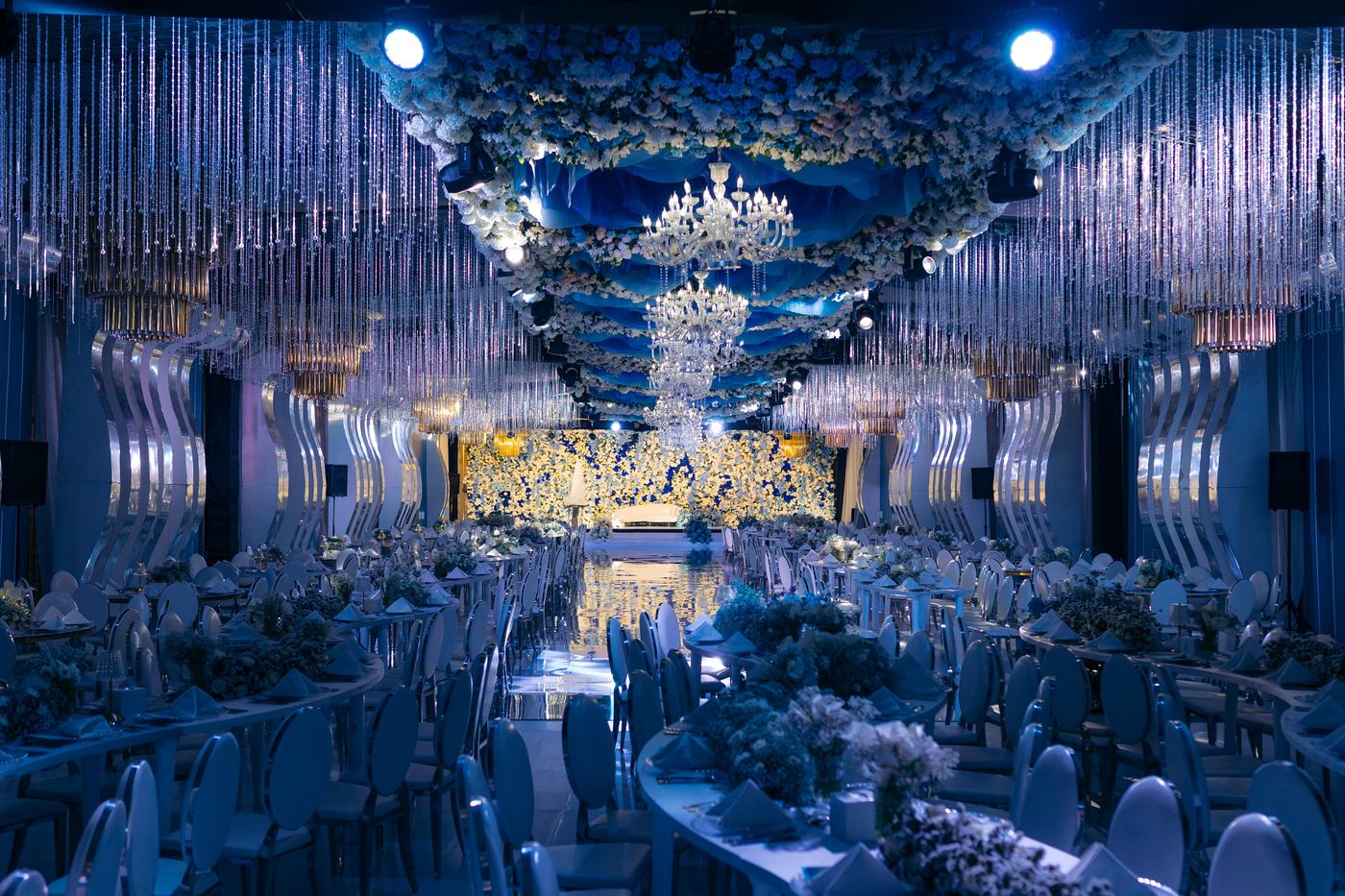 Blue crystal wedding reception — full ballroom view with floral ceiling and Venetian chandeliers, Kevins Events Tanzania