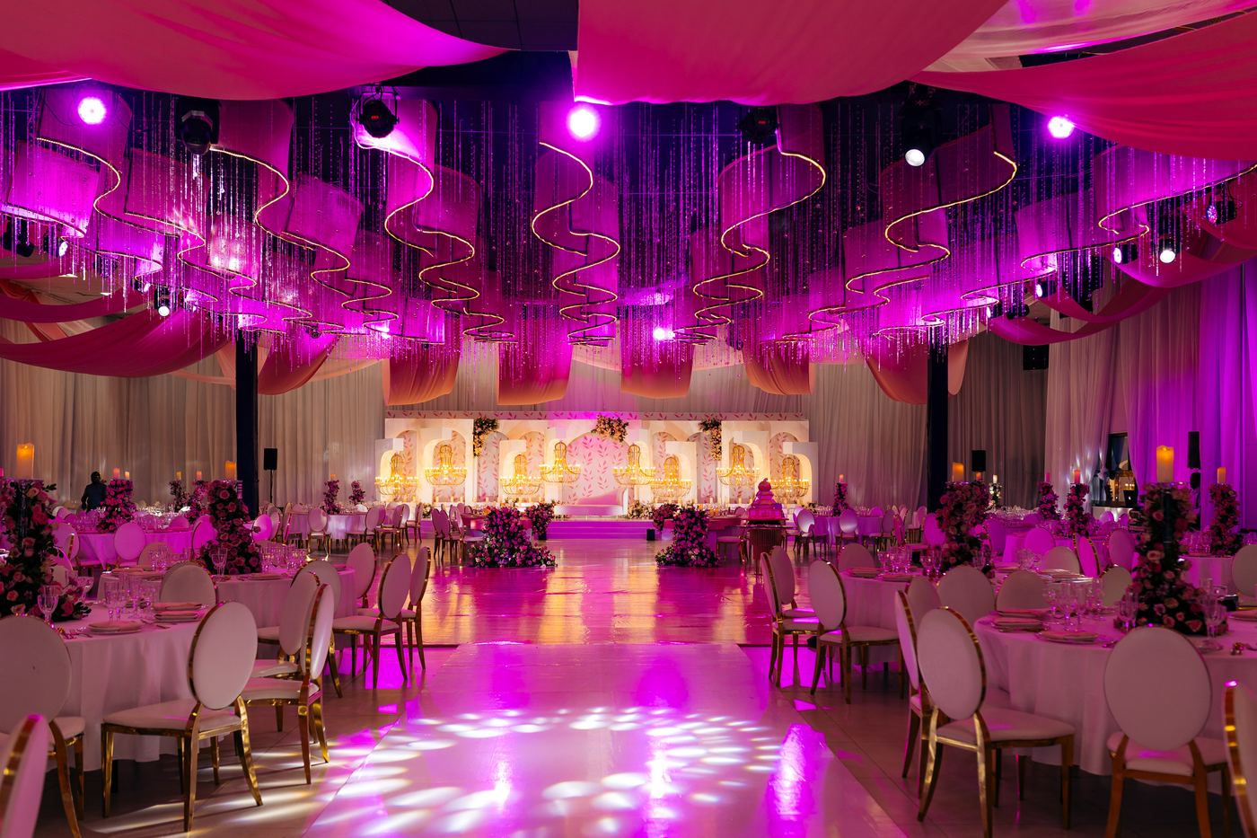 Pink wedding ballroom with gold chairs and rose florals — Kevins Events Dar es Salaam