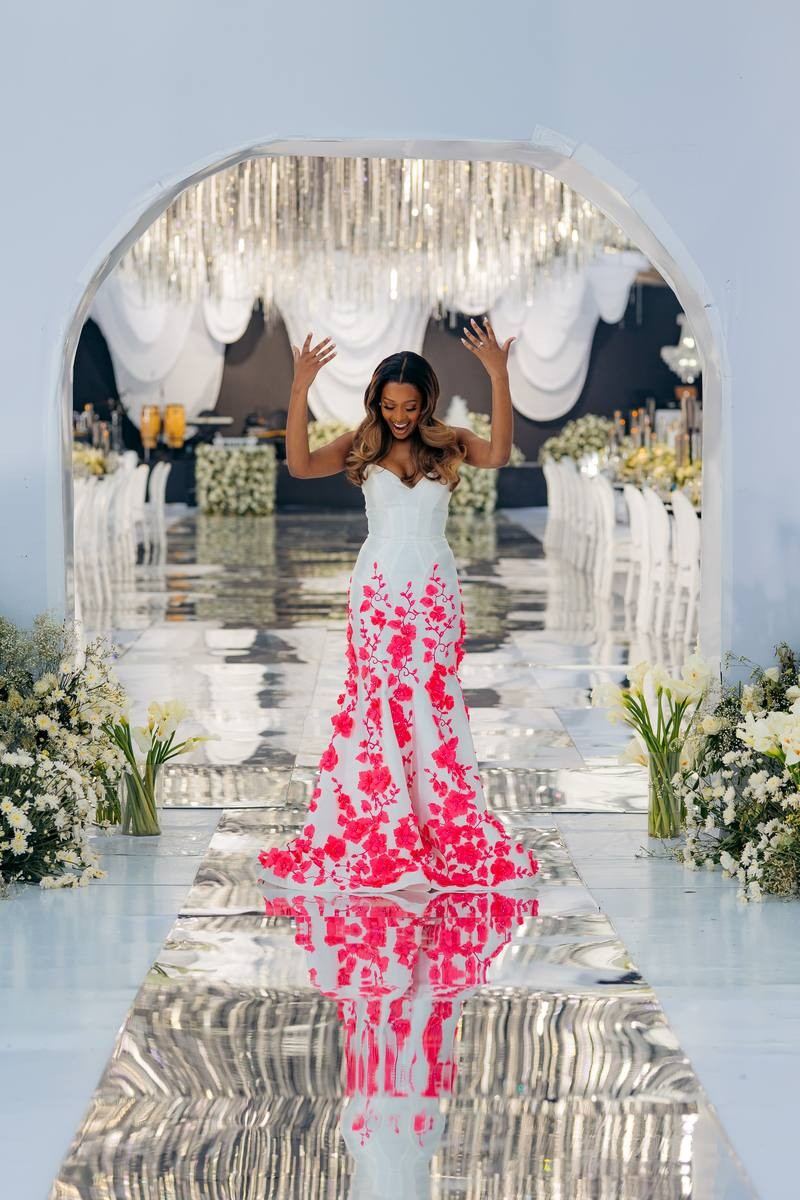 Luxury wedding ceremony setup — white and gold floral arch by Kevins Events Tanzania